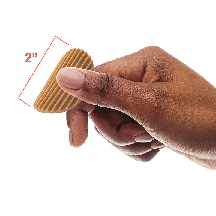 Black woman holding a wavy chip showing that it is 2 inches big