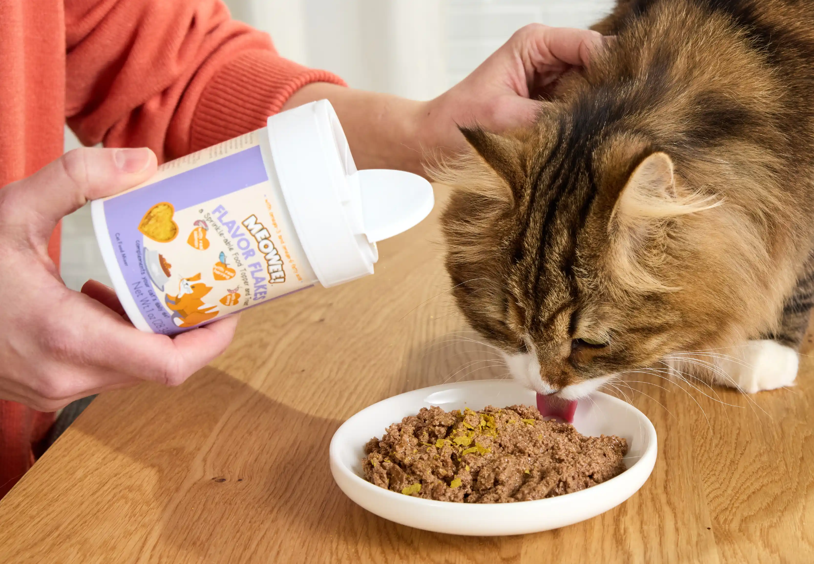 Cat eating food with meowee flake toppers